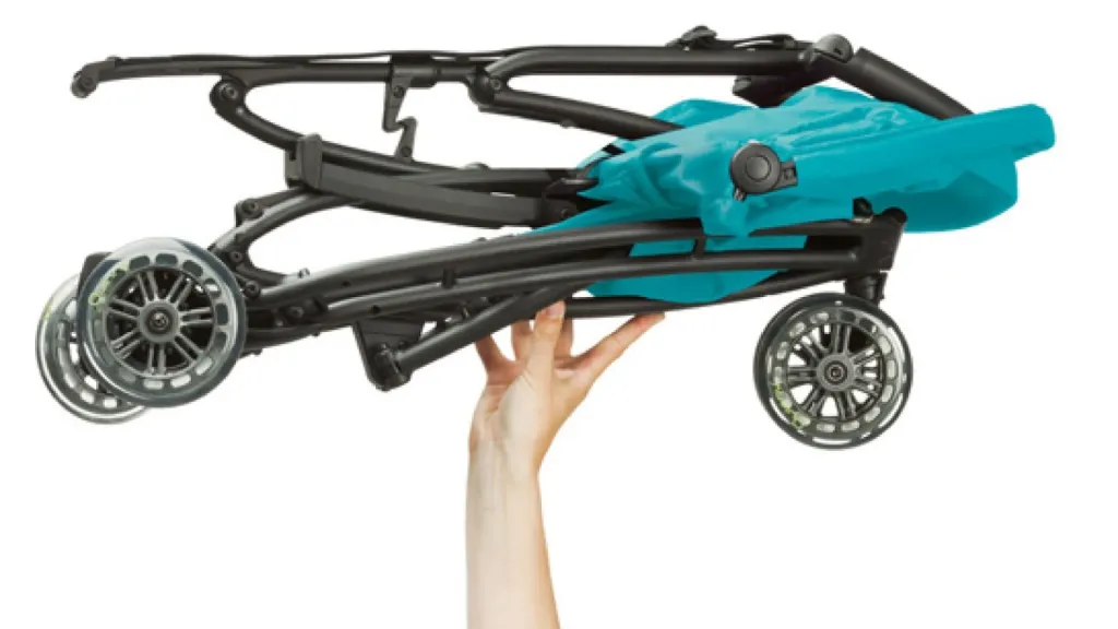 A folded Quinny Yezz buggy being carried in one hand.