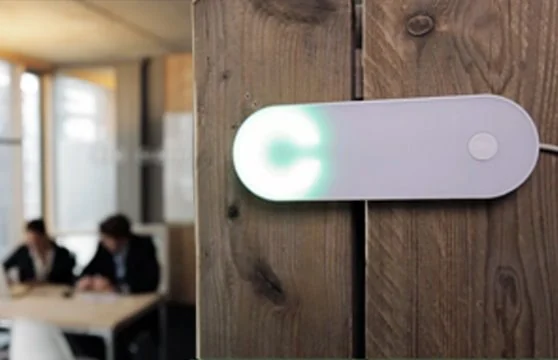 White Clay hardware with a green light on a wooden wall.