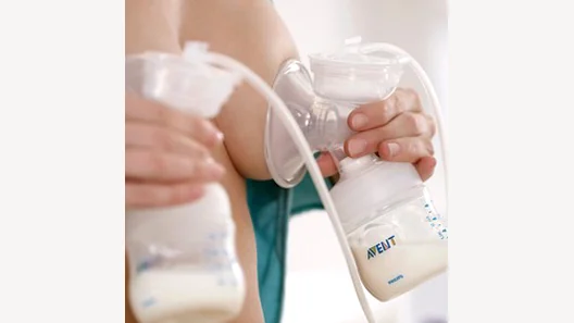 Detail of the Philips Avent breast pump in use.