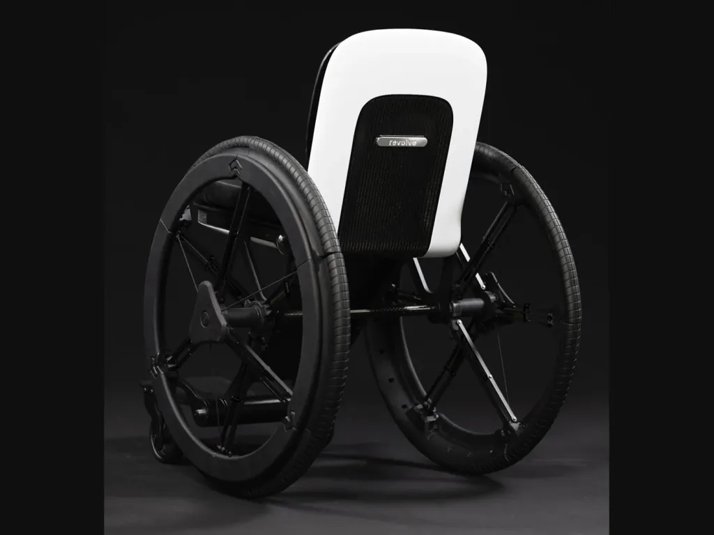 Black Revolve Air wheelchair viewed at an angle from the front against a dark background.
