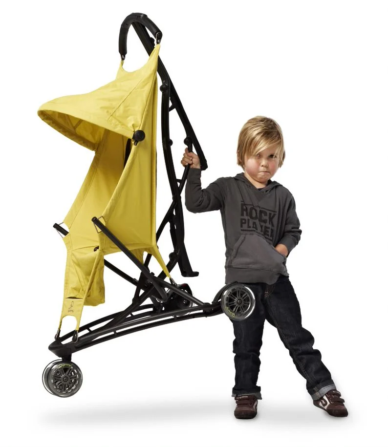 A child lifts a yellow Quinny Yezz by the frame.